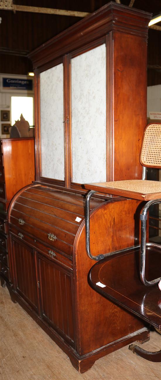 A late Victorian walnut roll top bureau bookcase